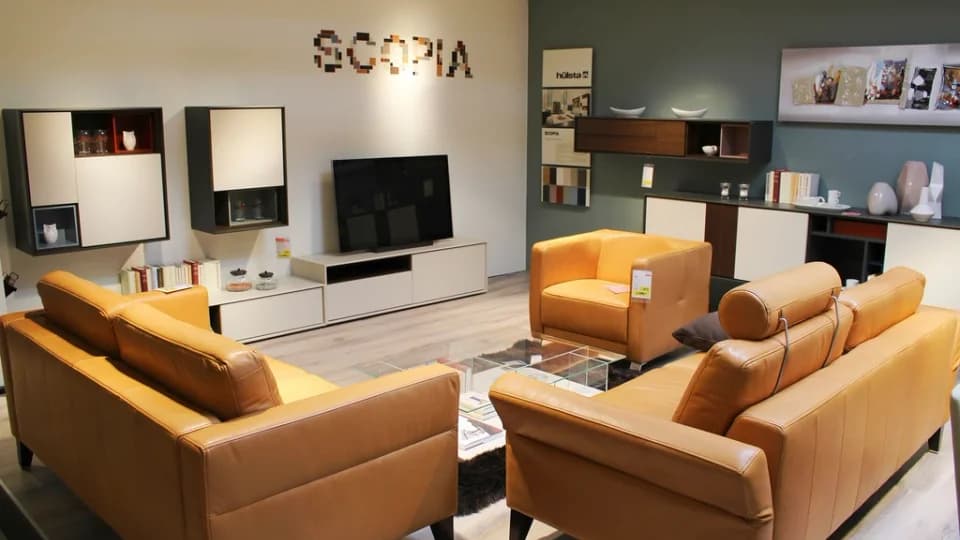 Showroom de mobilier avec canapés, meubles bas et éclairage d’exposition